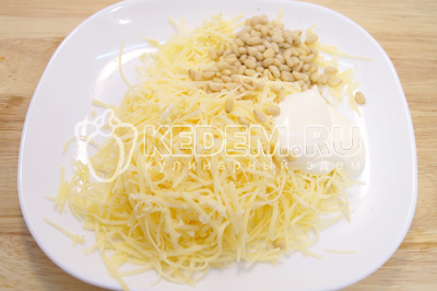 Смешать тертый сыр, кедровые орехи и майонез
