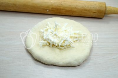 Выложить часть сырной начинки.