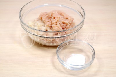 Перемолоть на мясорубке куриную грудку, лук и чеснок. Добавить 1/2 чайной ложки соли.