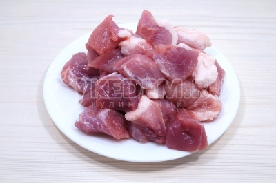 Чтобы приготовить мясо с картошкой в казане, нужно мякоть свинины нарезать небольшими кусочками.