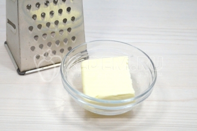 Чтобы приготовить рижская ватрушку, нужно 100 грамм замороженного сливочного масла натереть на крупной терке в миску.