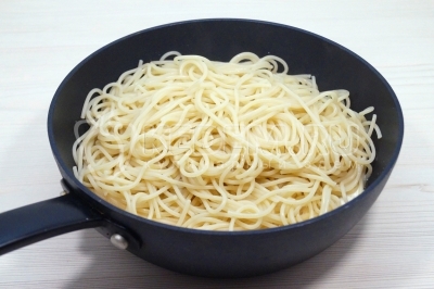 Добавить спагетти в сковороду к семге в сливочном соусе и перемешать. Подержать на огне 1-2 минуты.