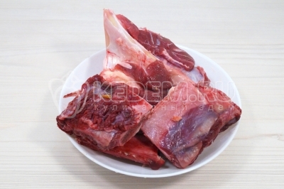 Чтобы приготовить рассольник с грибами и перловкой, нужно взять 500 грамм говяжьих костей и хорошо их вымыть.